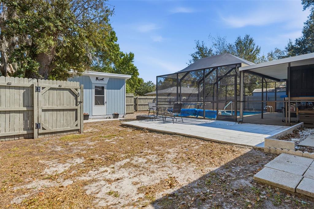 9381 Rosa Street Spring Hill, FL 34608 - Photo 18 of 26 a view of a house with backyard and sitting area