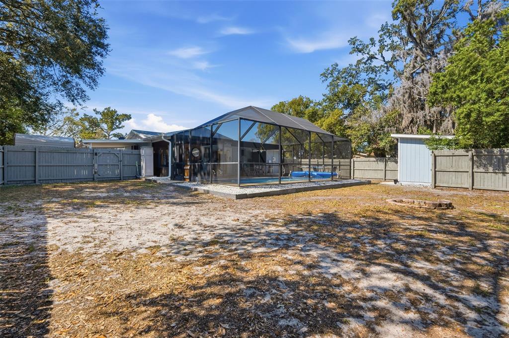 9381 Rosa Street Spring Hill, FL 34608 - Photo 20 of 26 a view of a house with a yard