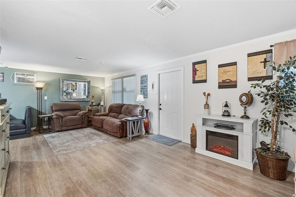 9381 Rosa Street Spring Hill, FL 34608 - Photo 3 of 26 a living room with fireplace furniture and a fireplace