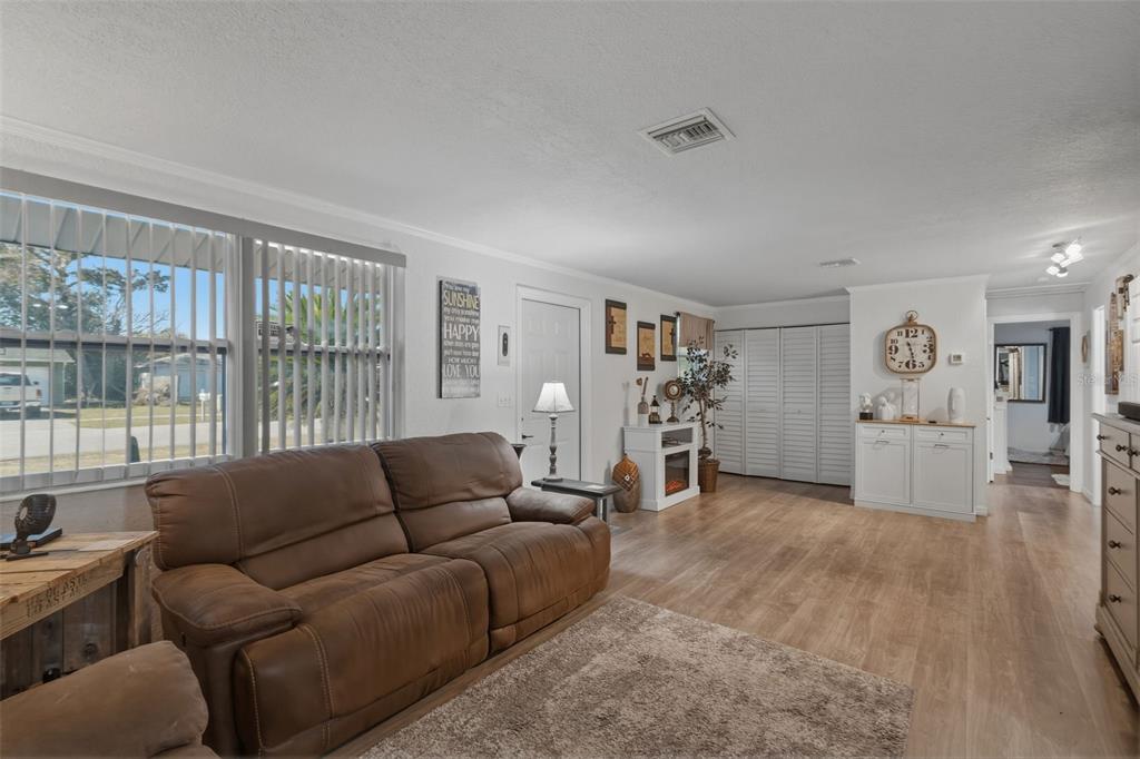 9381 Rosa Street Spring Hill, FL 34608 - Photo 5 of 26 a living room with furniture and a large window