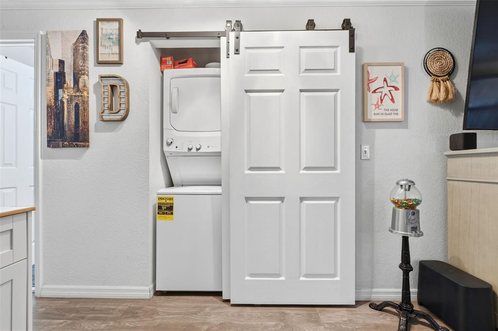 9381 Rosa Street Spring Hill, FL 34608 - Photo 8 of 26 a bathroom with a refrigerator and a table
