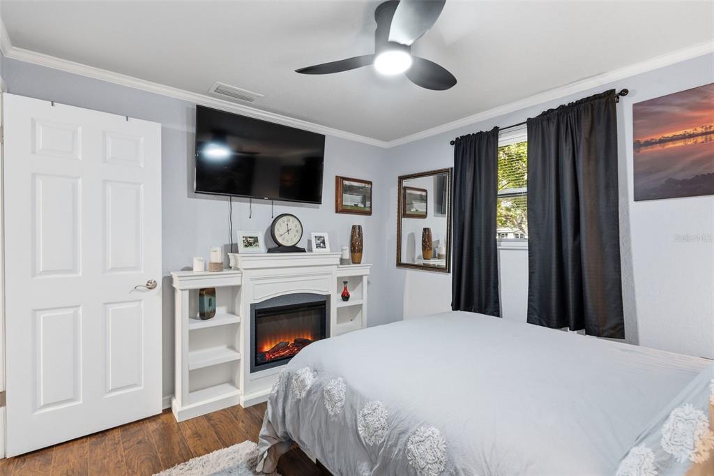9381 Rosa Street Spring Hill, FL 34608 - Photo 10 of 26 a bedroom with a bed and a flat screen tv