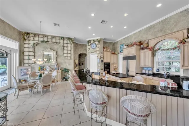 a large dining space with furniture and a large window