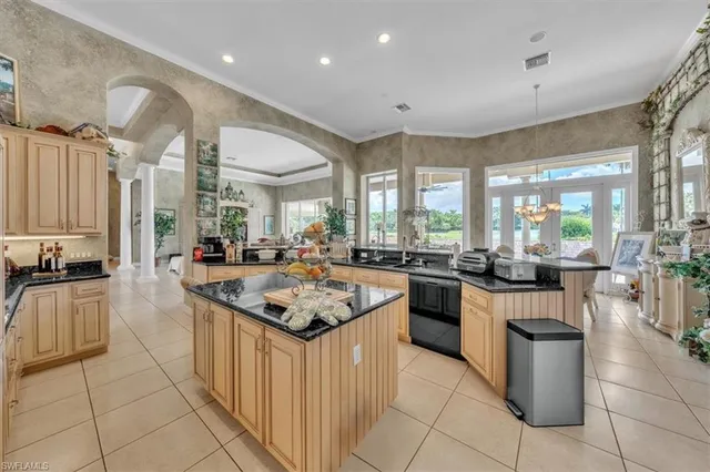 a kitchen with counter top space appliances and windows