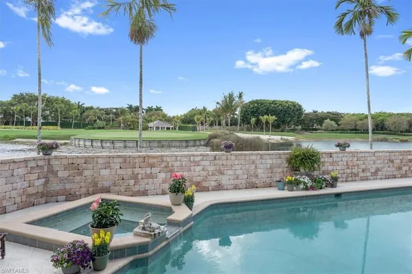 a view of a swimming pool with outdoor seating