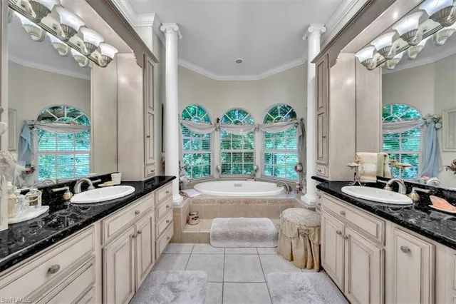 a spacious bathroom with a granite countertop double vanity and a large mirror