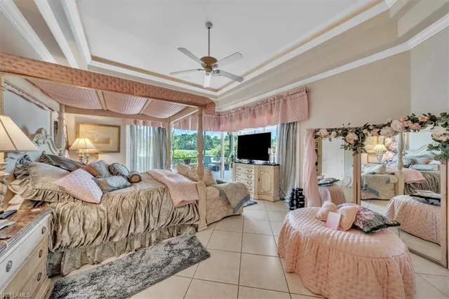 a bedroom with a bed a window and a flat screen tv