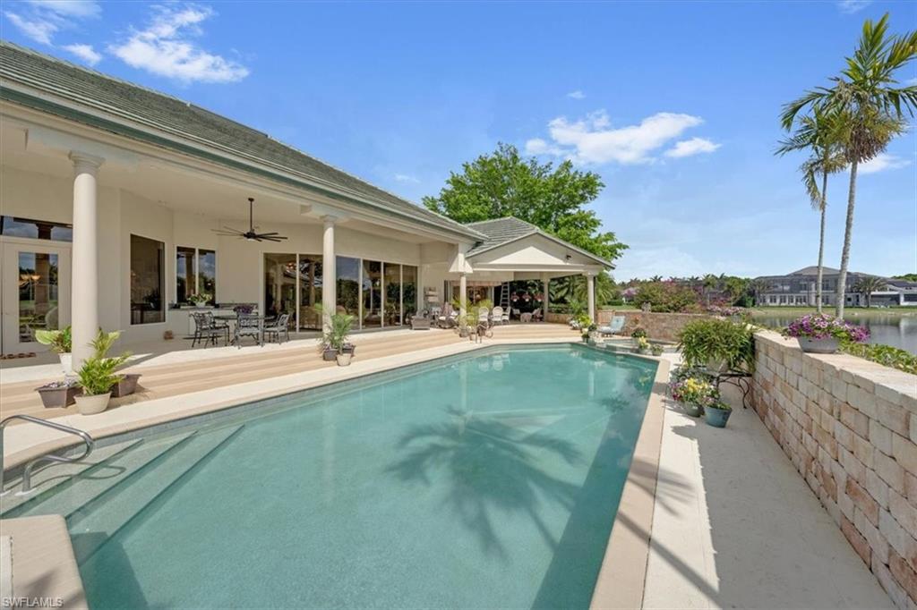 2339 Alexander Palm Naples, FL 34105 - Photo 30 of 45 a view of a swimming pool with a patio