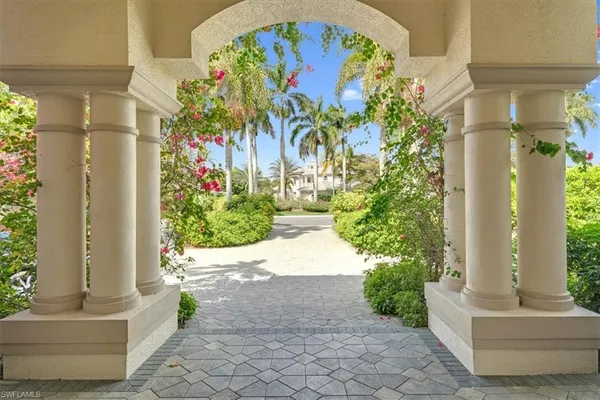 a view of a door with potted plants and door