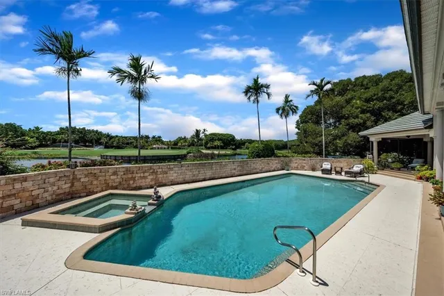 a view of a swimming pool with a lounge chair