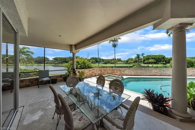 a view of a porch with furniture and a yard