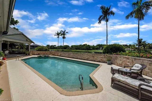 a view of a swimming pool with a table and chairs