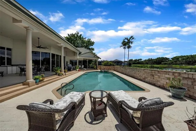 a view of a swimming pool with lounge chair