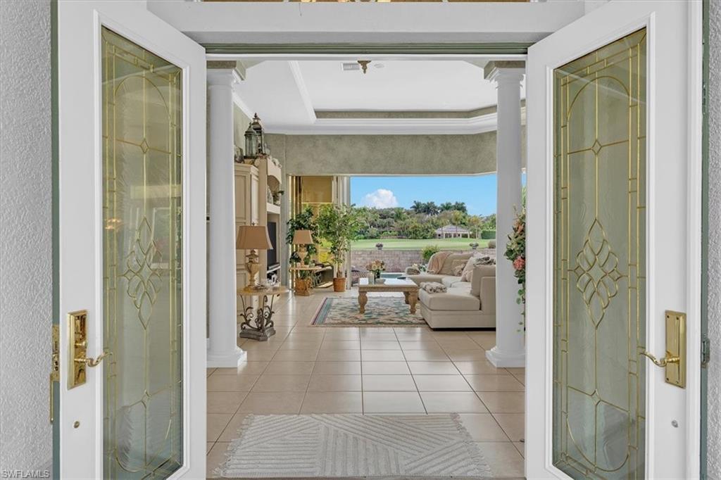 2339 Alexander Palm Naples, FL 34105 - Photo 4 of 45 a living room with furniture and a chandelier