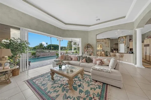 a living room with furniture large windows and a flat screen tv