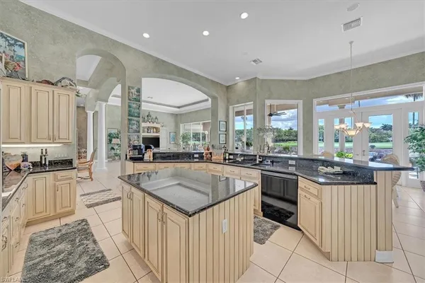 a living room with patio furniture and a floor to ceiling window