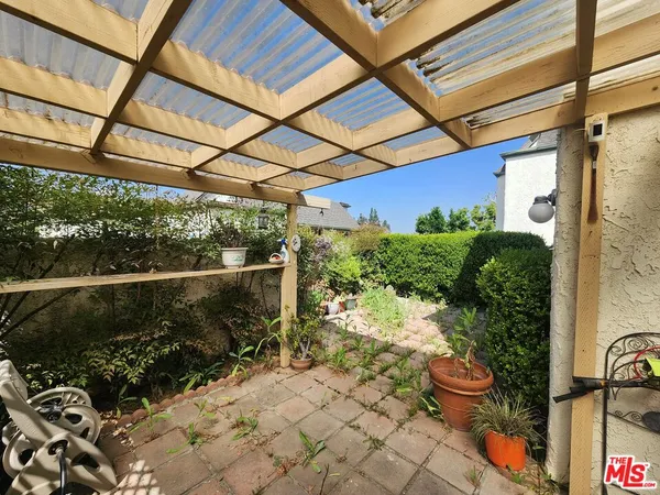 a view of a backyard with plants and a garden