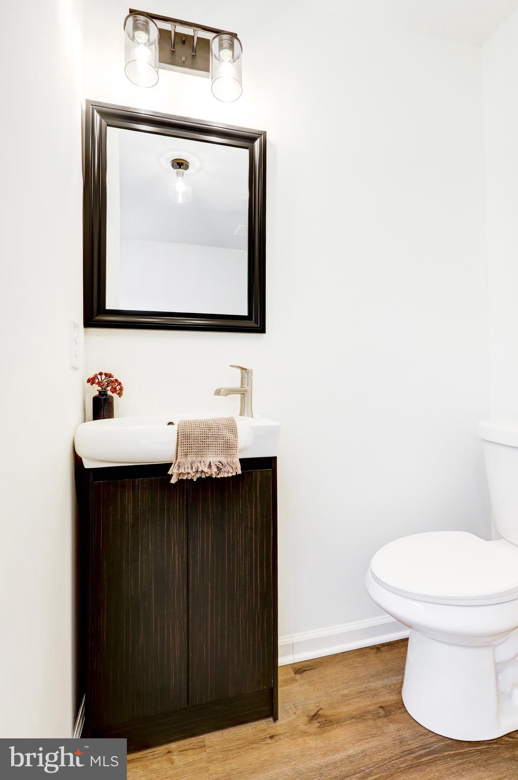 31 Nature Lane Levittown, PA 19054 - Photo 13 of 33 a bathroom with a toilet a sink and mirror