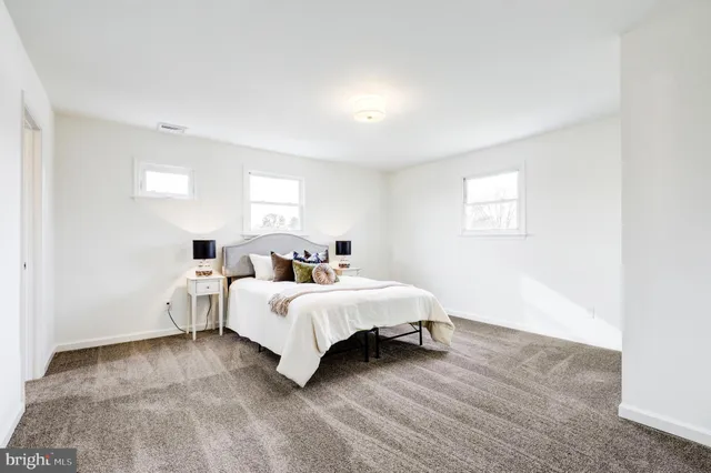 a bed room with a bed and a night stand