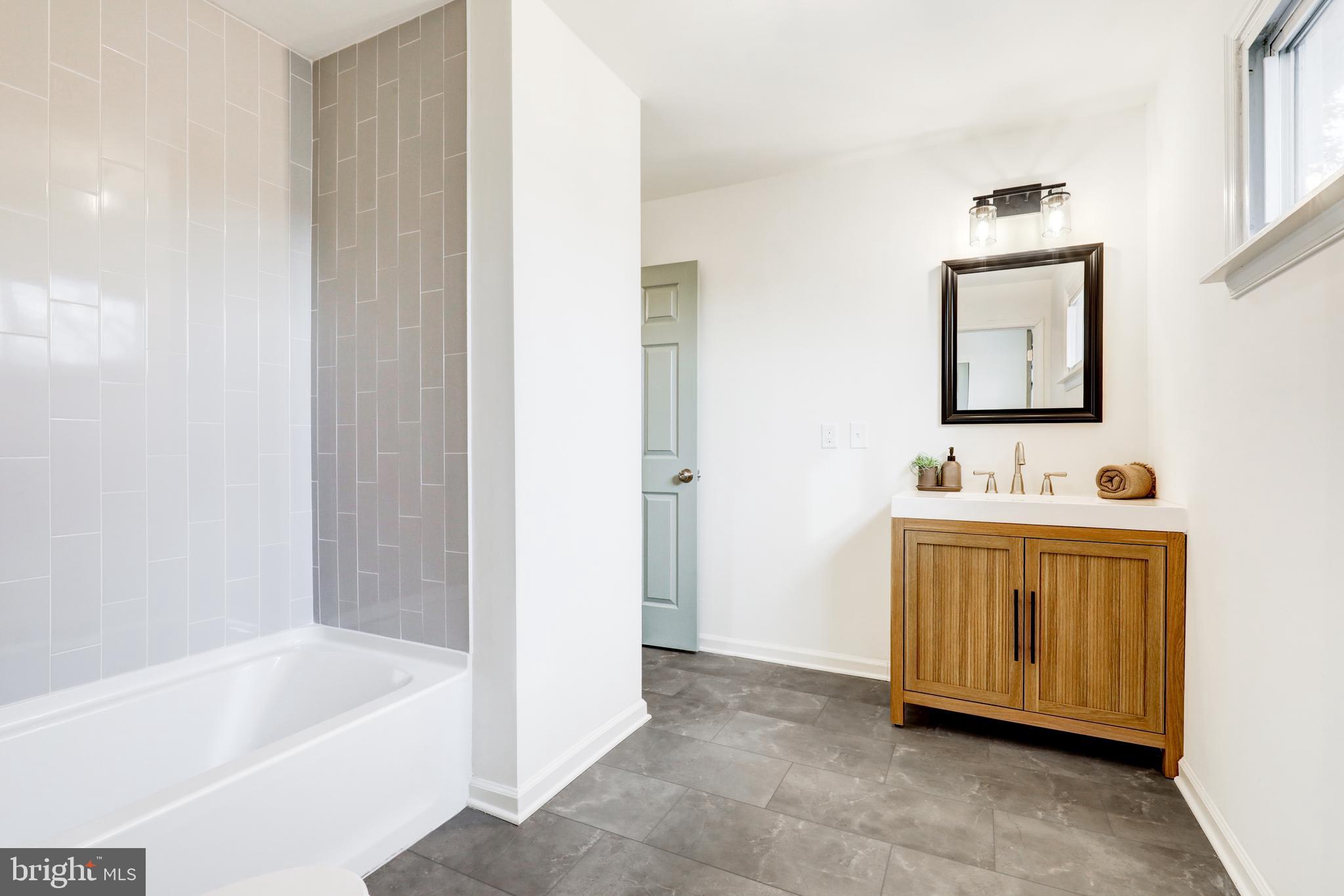 31 Nature Lane Levittown, PA 19054 - Photo 21 of 33 a bathroom with a tub sink and mirror