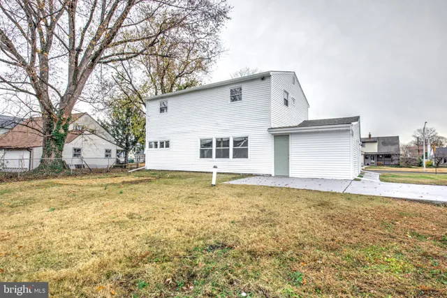 a house view with swimming pool in front of it