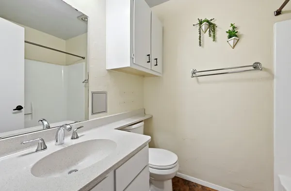 a bathroom with a sink mirror and toilet