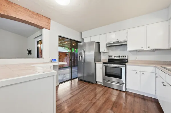 a kitchen with stainless steel appliances a refrigerator stove and sink