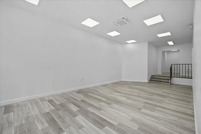 a view of empty room with wooden floor