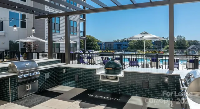 a view of a roof deck with couches chairs and wooden floor