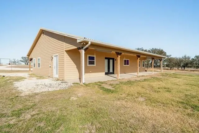 a house with trees in the background