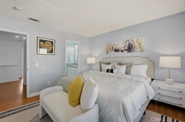 a bedroom with a bed and wall painting