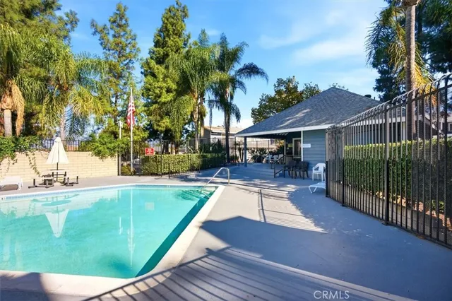 a view of a house with swimming pool and sitting area