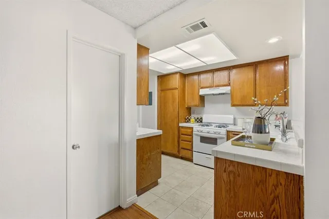 a kitchen with a sink appliances cabinets and a counter top space