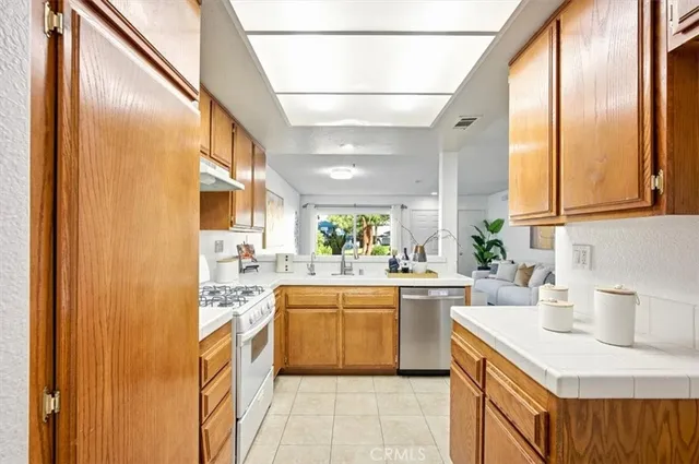 a kitchen with a sink stove and cabinets