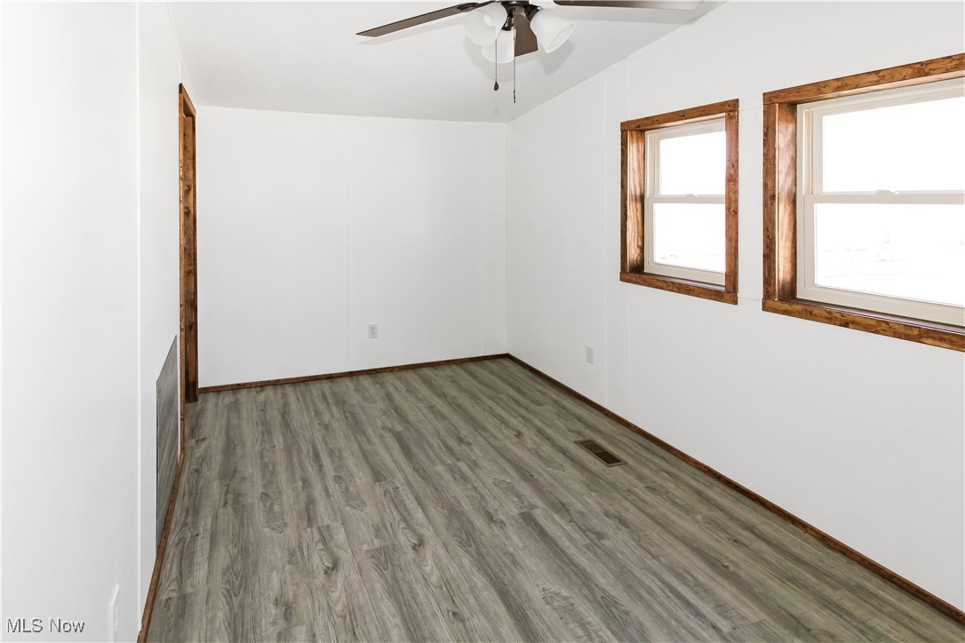 265 Meachem Road, Unit 41 Port Clinton, OH 43452 - Photo 15 of 33 Unfurnished room with visible vents, wood finished floors, and a ceiling fan
