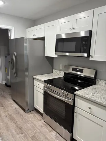 a kitchen with stainless steel appliances and cabinets