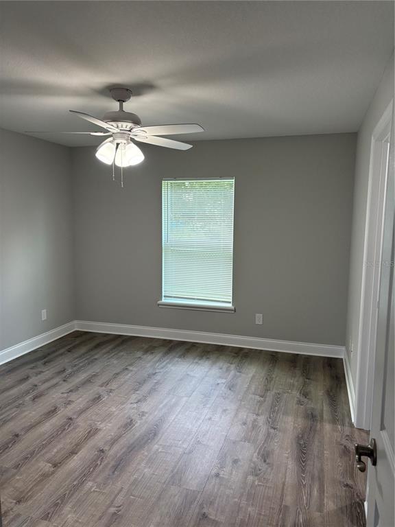 514 2nd Street Southwest Fort Meade, FL 33841 - Photo 12 of 21 an empty room with wooden floor fan and windows