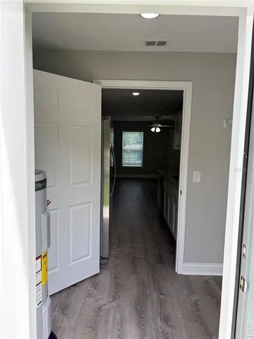 a view of a hallway view with wooden floor and staircase
