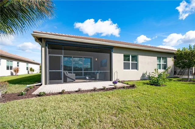 a large tree in front of a house