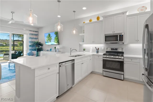 a kitchen with a sink cabinets and stainless steel appliances