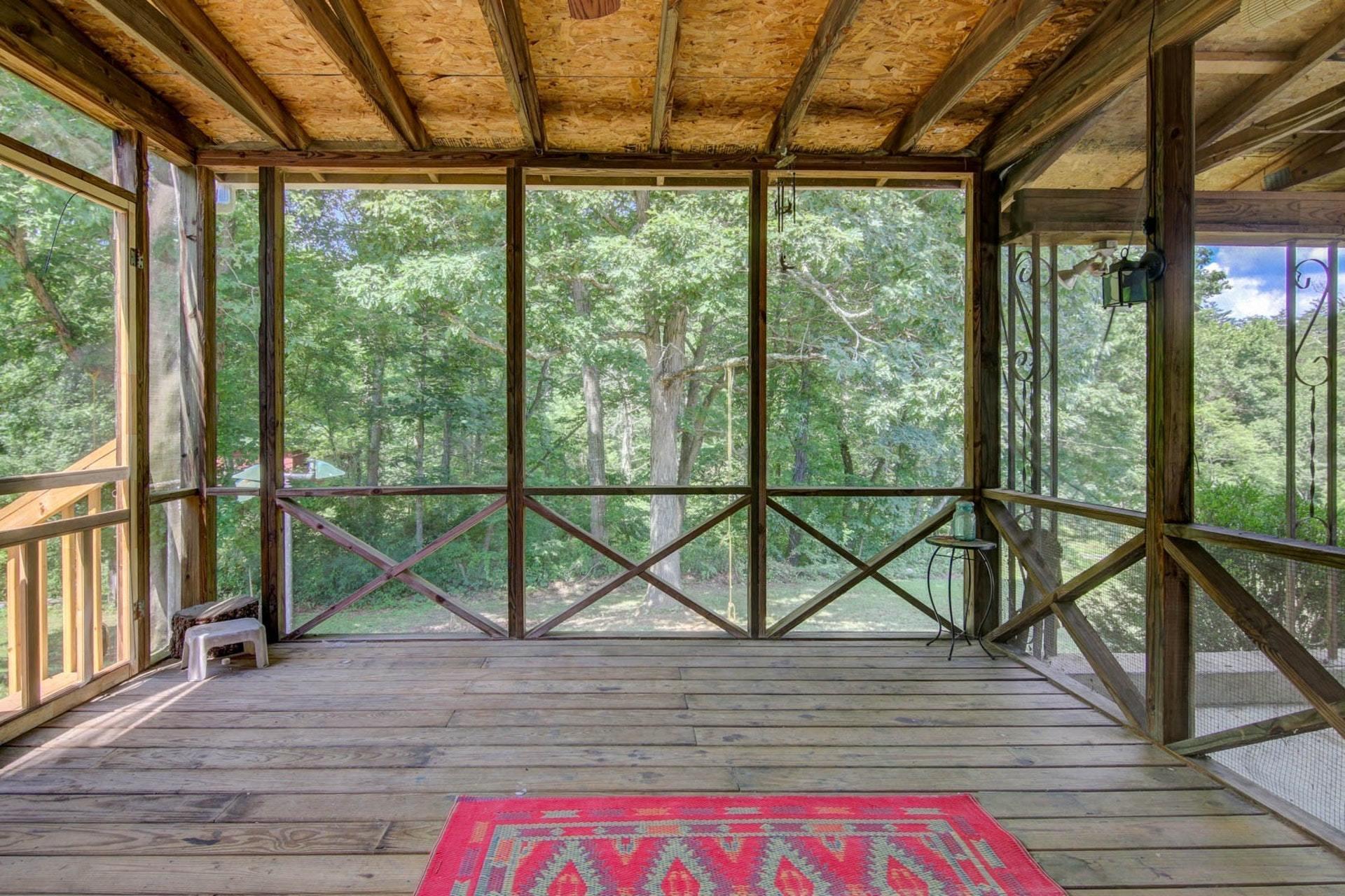 580 Mt Pleasant Church Road Fincastle, VA 24090 - Photo 28 of 39 a view of a balcony with wooden floor and iron stairs