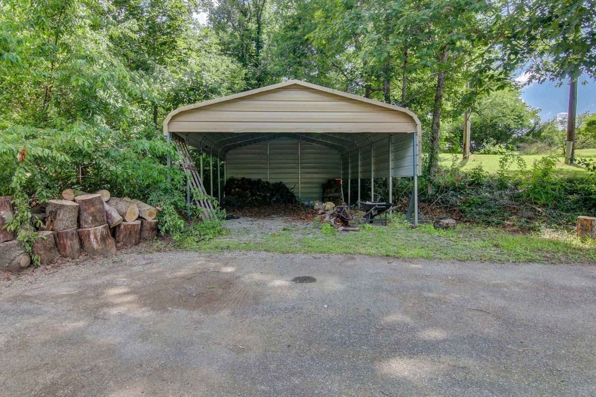 580 Mt Pleasant Church Road Fincastle, VA 24090 - Photo 35 of 39 a view of a barn with large trees and a small yard