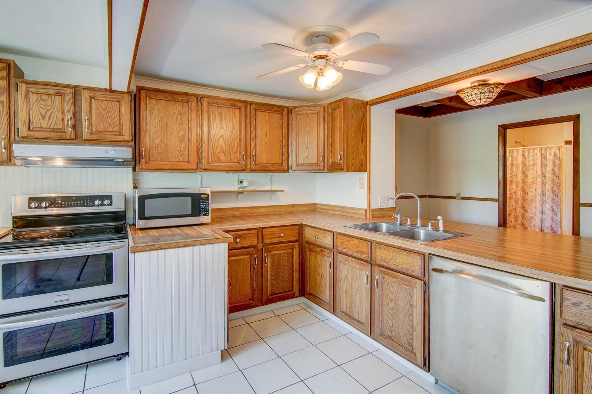 580 Mt Pleasant Church Road Fincastle, VA 24090 - Photo 5 of 39 a kitchen with stainless steel appliances granite countertop a sink and cabinets