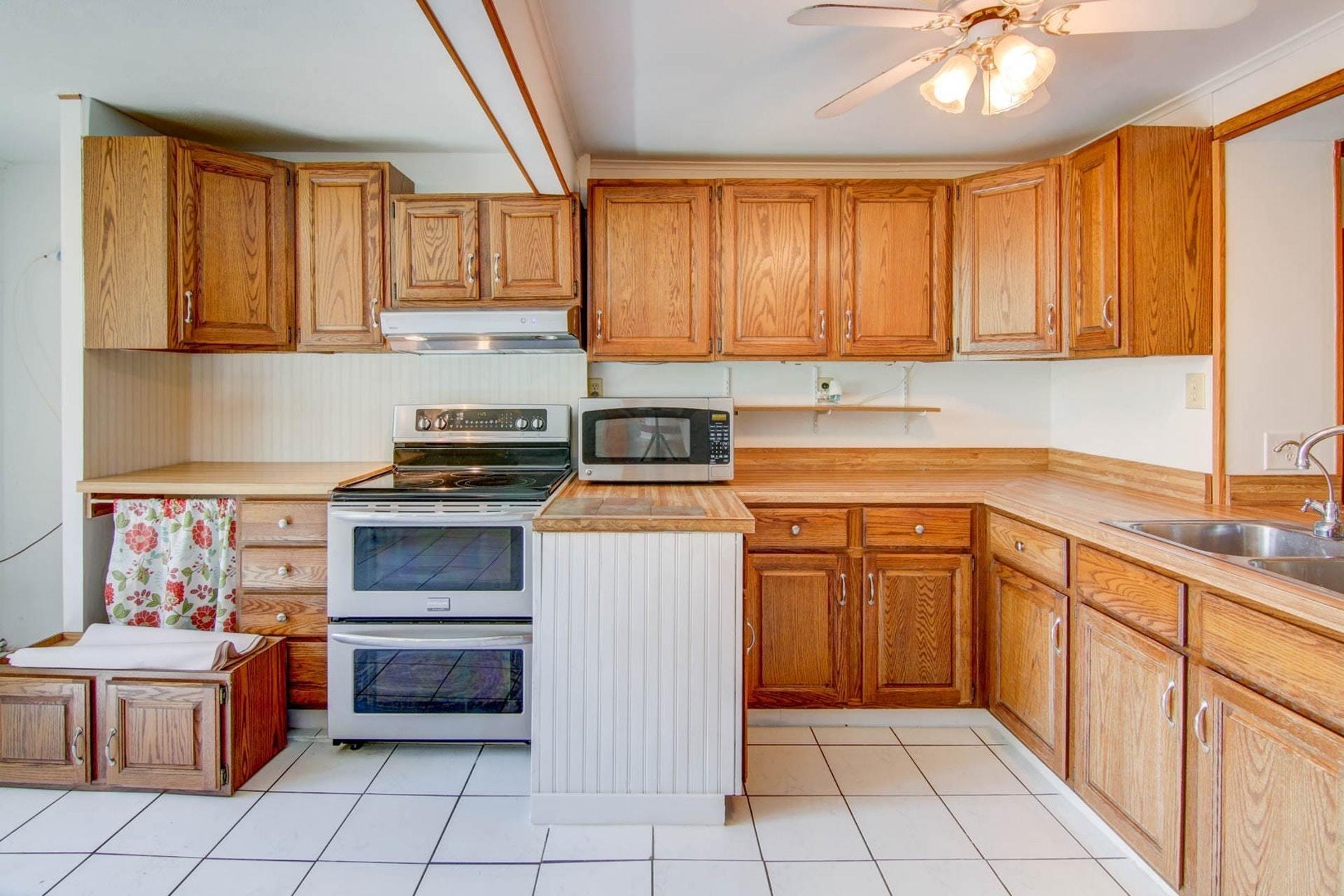 580 Mt Pleasant Church Road Fincastle, VA 24090 - Photo 6 of 39 a kitchen with a refrigerator sink and cabinets