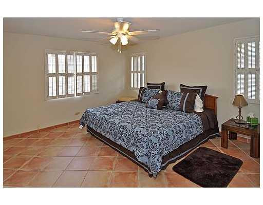 7481 Plantation Road Plantation, FL 33317 - Photo 12 of 17 a bedroom with a large bed and a chandelier