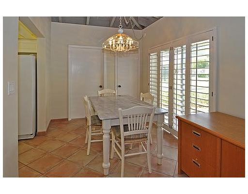 7481 Plantation Road Plantation, FL 33317 - Photo 4 of 17 a view of dining room and kitchen with a table chairs and chandelier