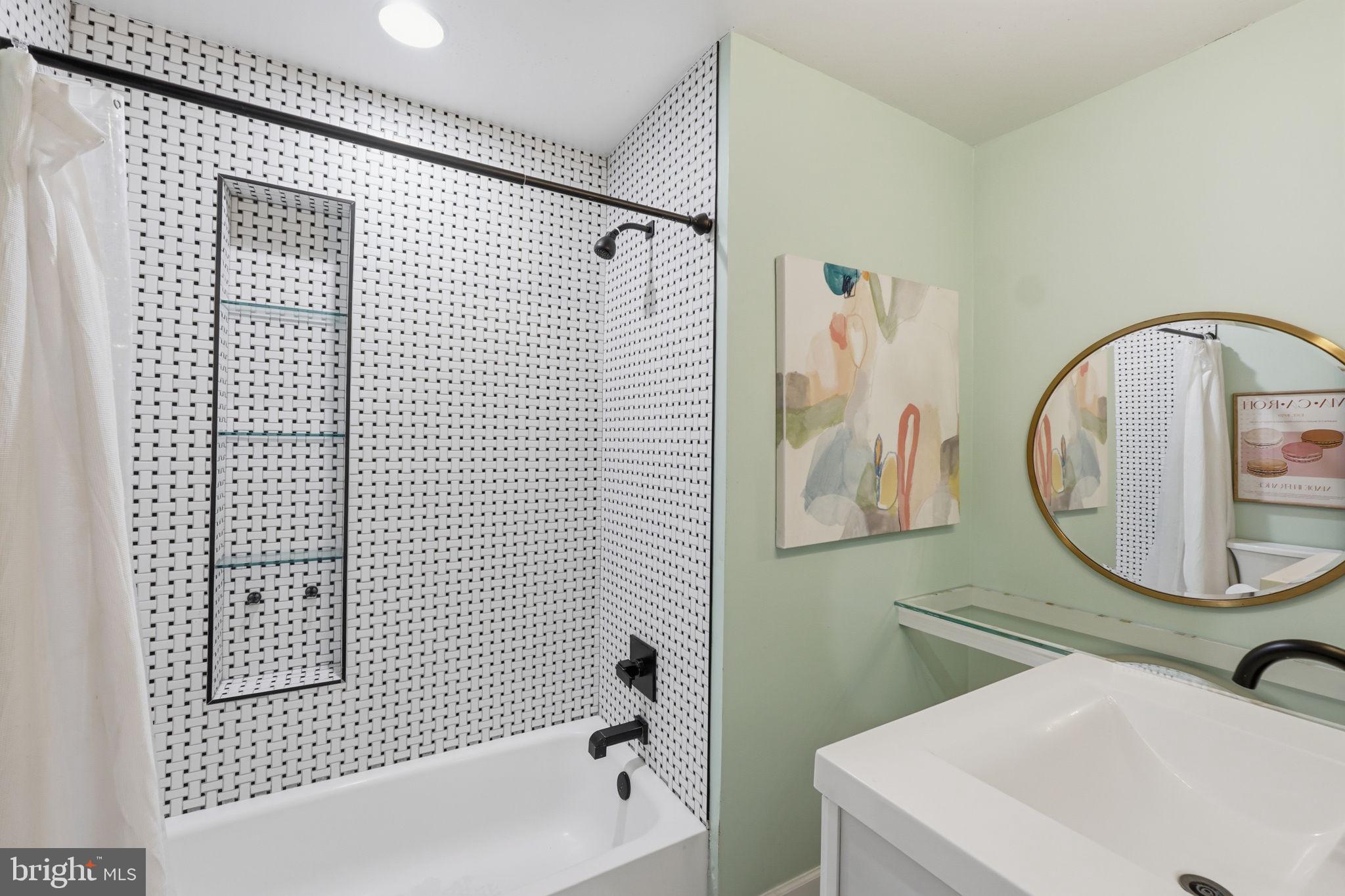 3523 Hamlet Place, Unit 501 Chevy Chase, MD 20815 - Photo 22 of 37 a bathroom with a sink a mirror a toilet and bathtub