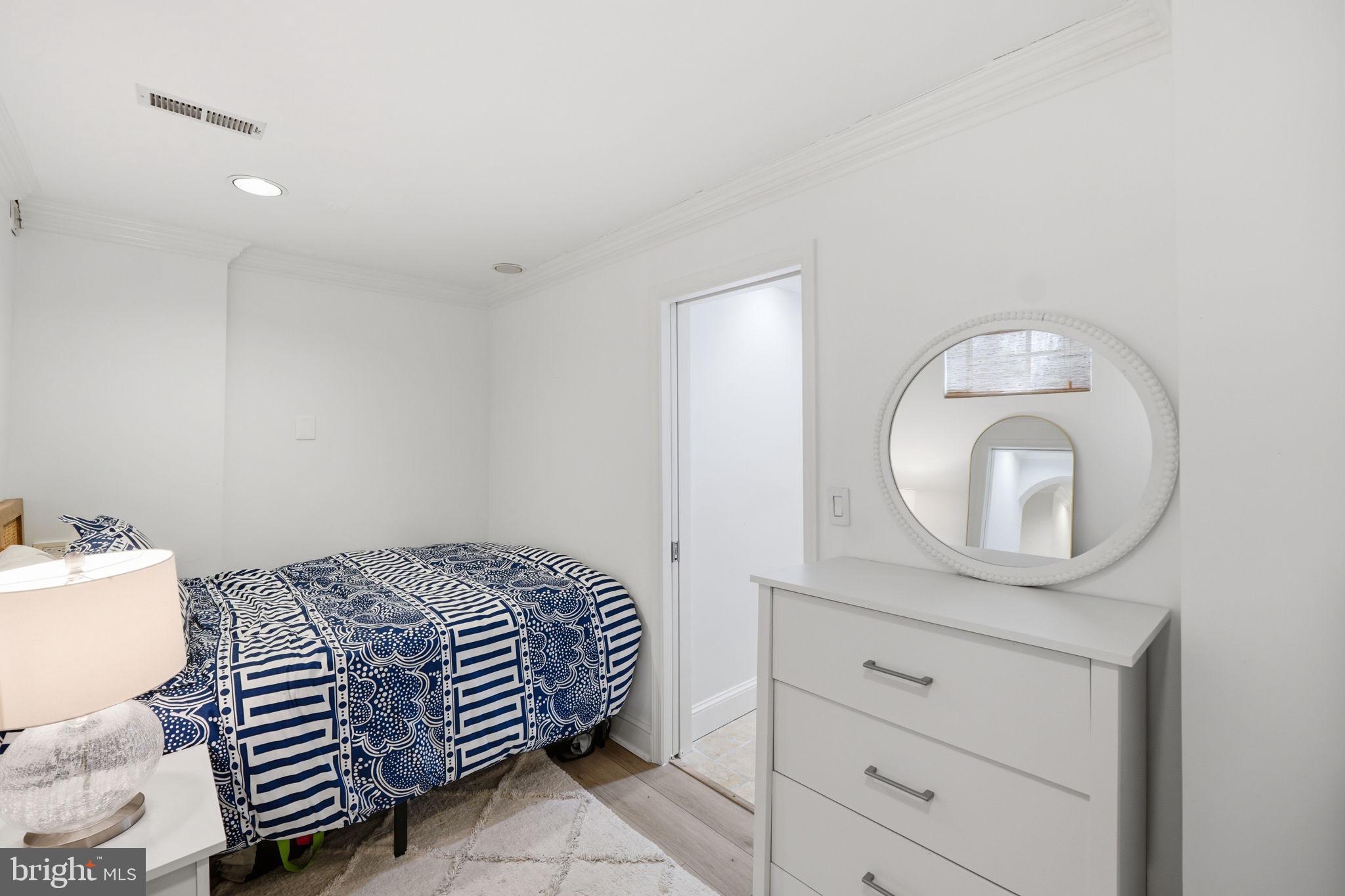 3523 Hamlet Place, Unit 501 Chevy Chase, MD 20815 - Photo 31 of 37 a bedroom with a bed and a mirror
