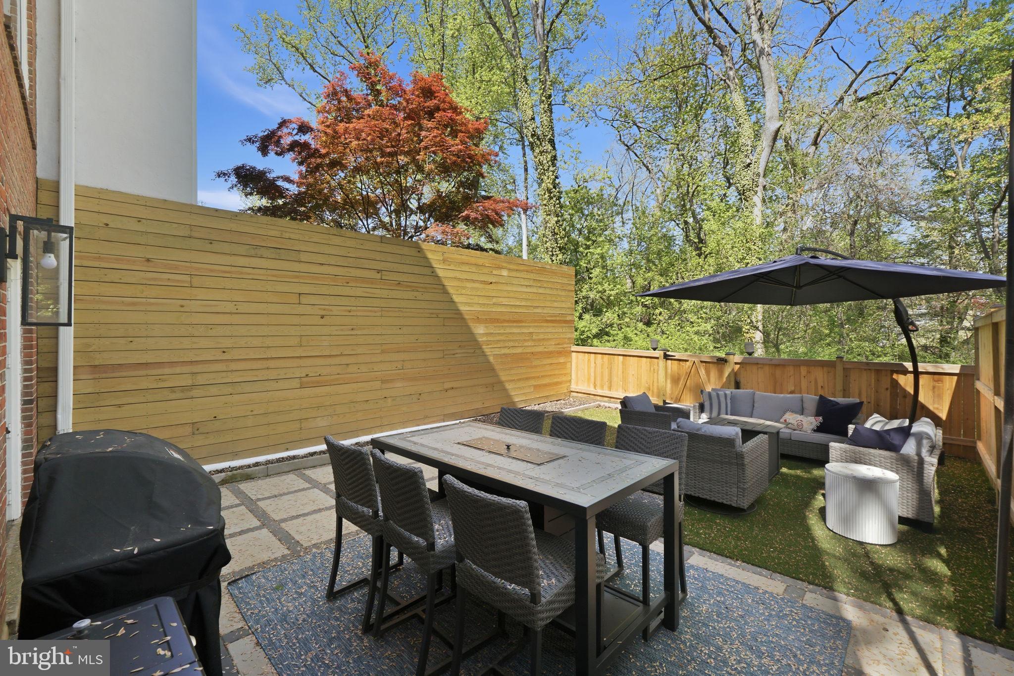 3523 Hamlet Place, Unit 501 Chevy Chase, MD 20815 - Photo 32 of 37 a backyard of a house with table and chairs
