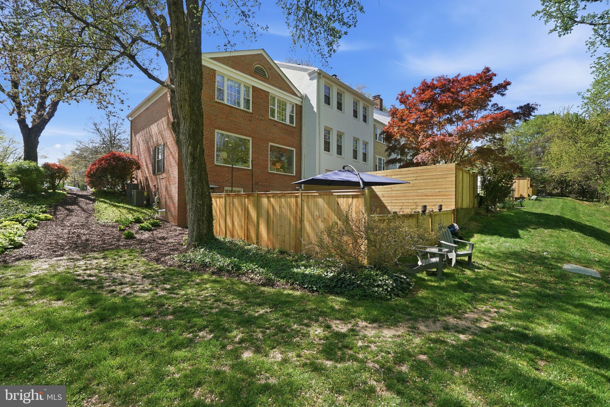 3523 Hamlet Place, Unit 501 Chevy Chase, MD 20815 - Photo 36 of 37 a view of a backyard with plants and a fountain